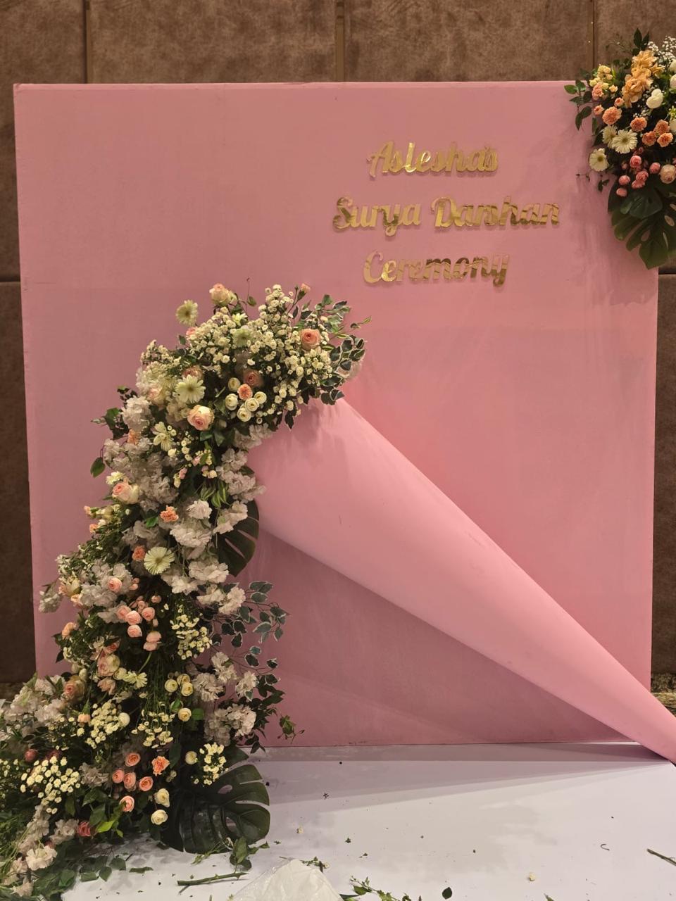 Creative pink backdrop for Surya Darshan ceremony