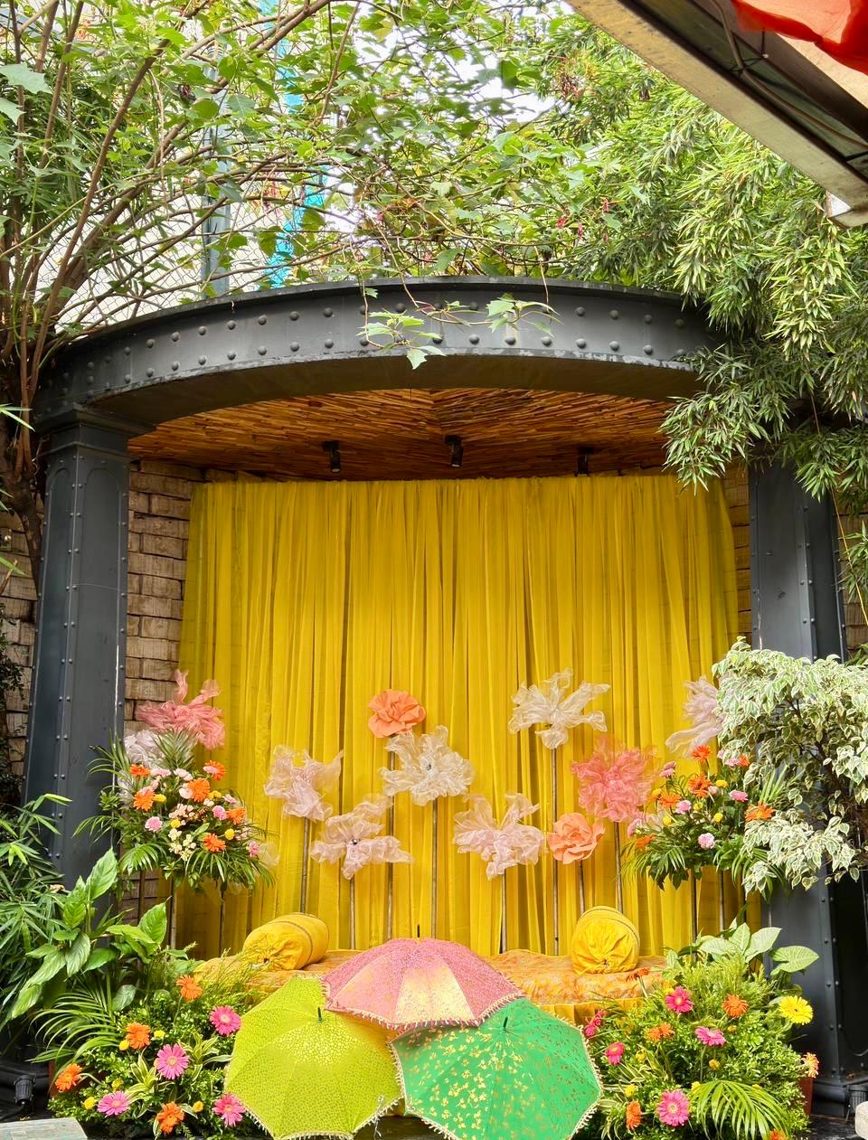 Festive yellow seating backdrop setup for Haldi ceremony