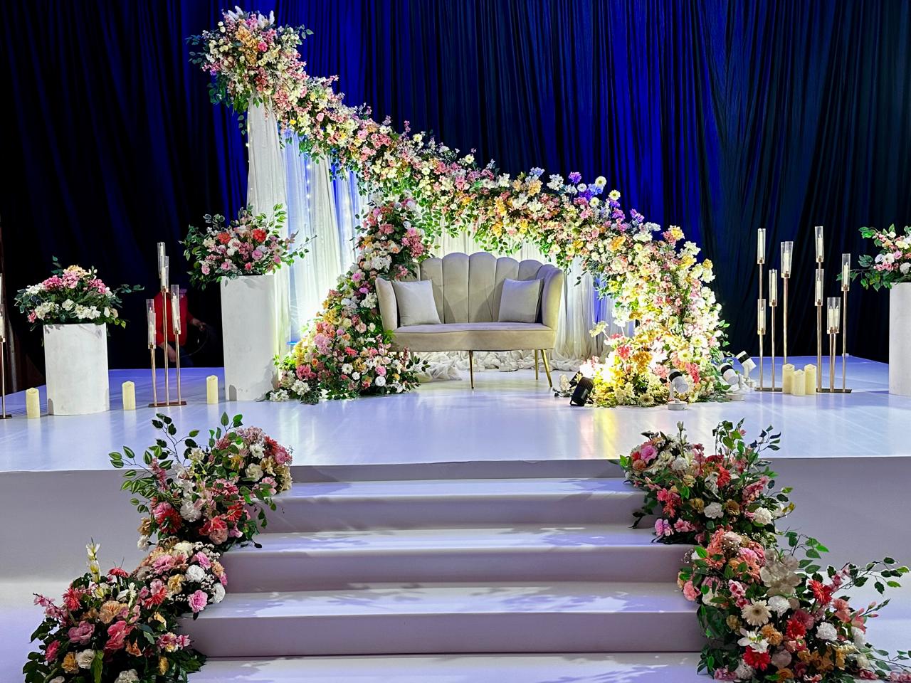 Luxury wedding stage setup with massive floral arch