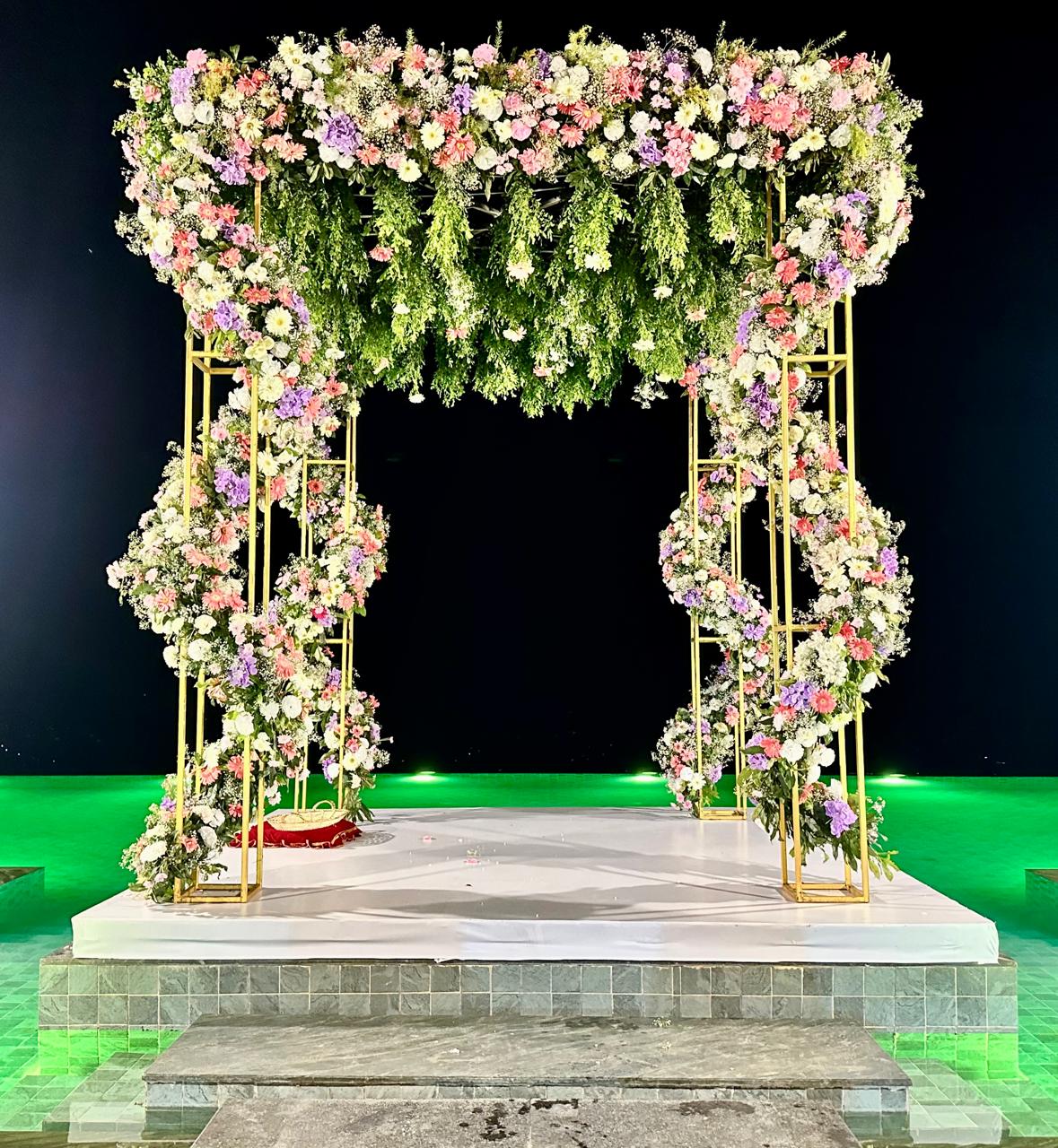 Exquisite night view of a wedding mandap by the pool