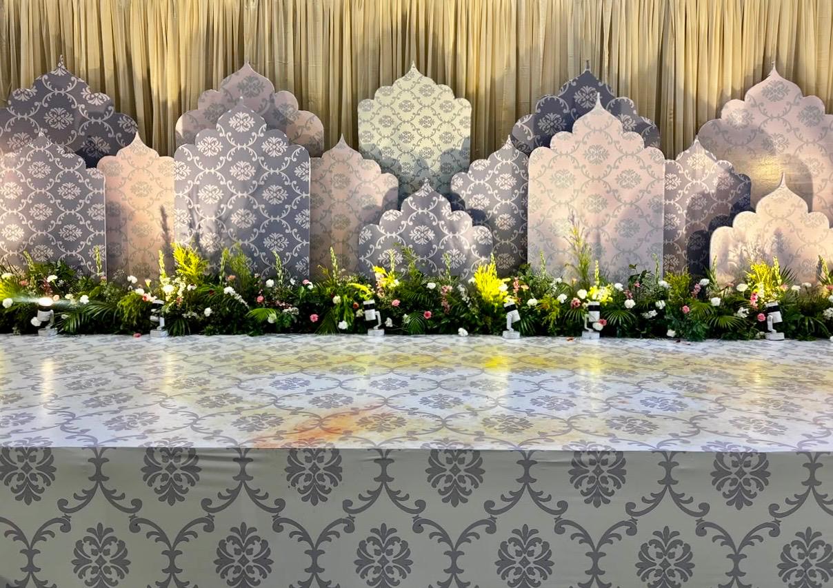 Traditional patterned wedding stage setup with panel cutouts