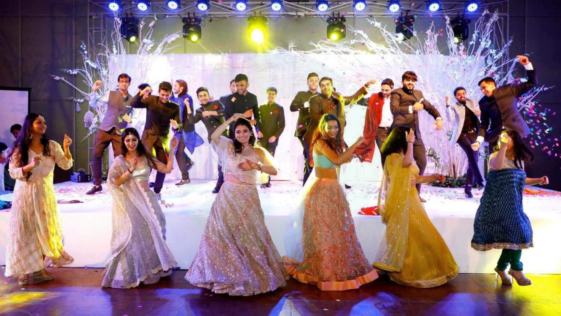 Vibrant Sangeet ceremony with colorful lighting and high-energy performances.