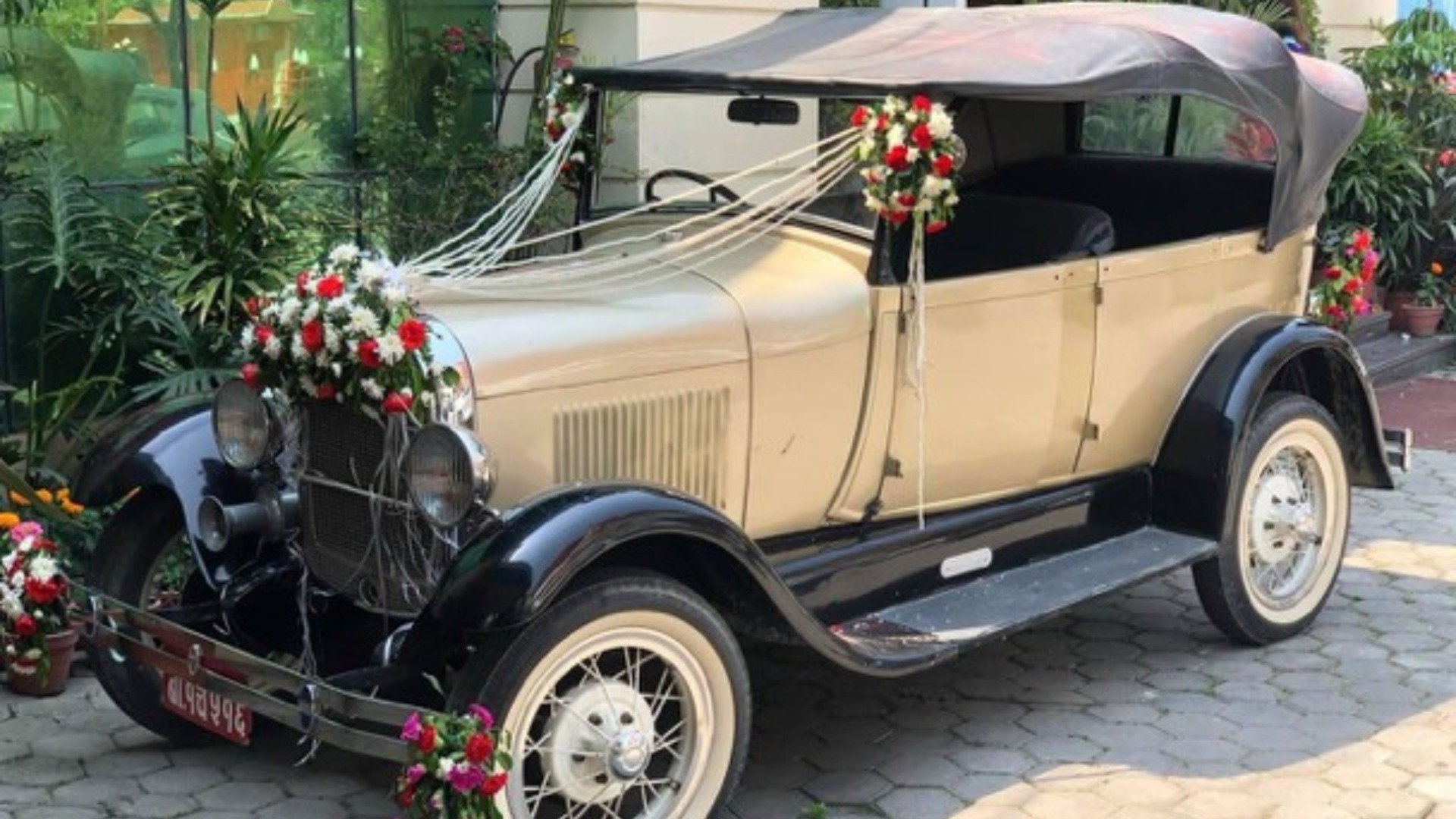Classic vintage car elegantly decorated for the couple's grand entrance.