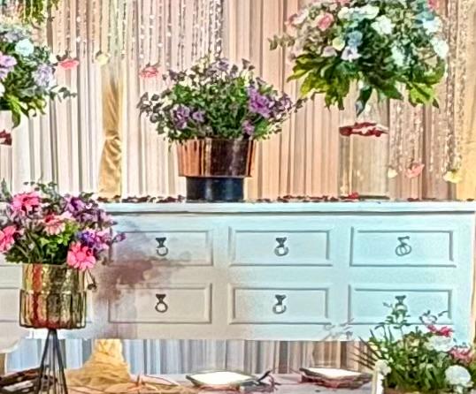 Close-up floral arrangement on decorative display drawers